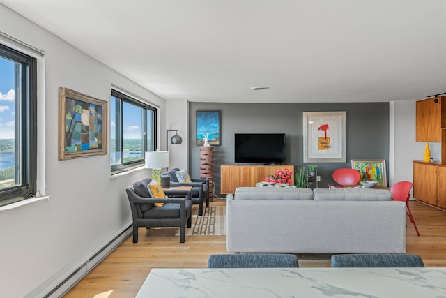 living room featuring a baseboard radiator and light wood-type flooring