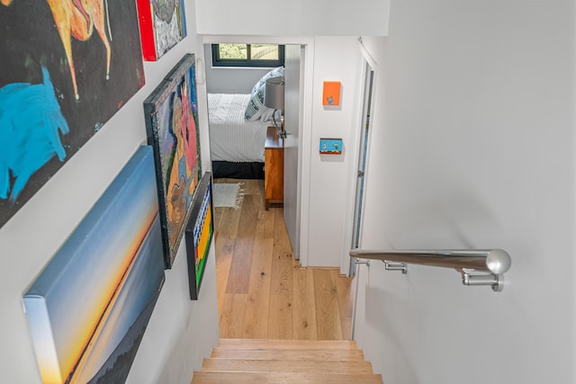 staircase with hardwood / wood-style flooring