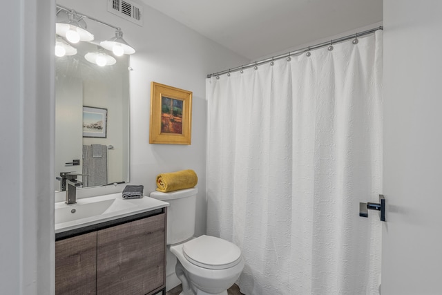 bathroom featuring toilet and vanity