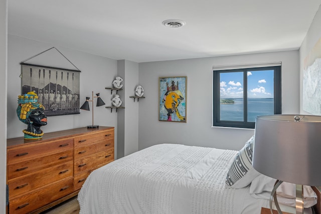 bedroom featuring a water view