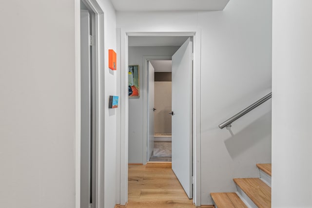 corridor with light hardwood / wood-style flooring