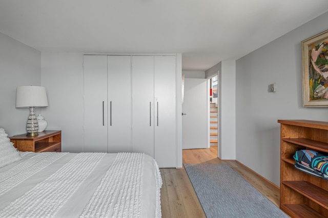 bedroom with a closet and light hardwood / wood-style floors