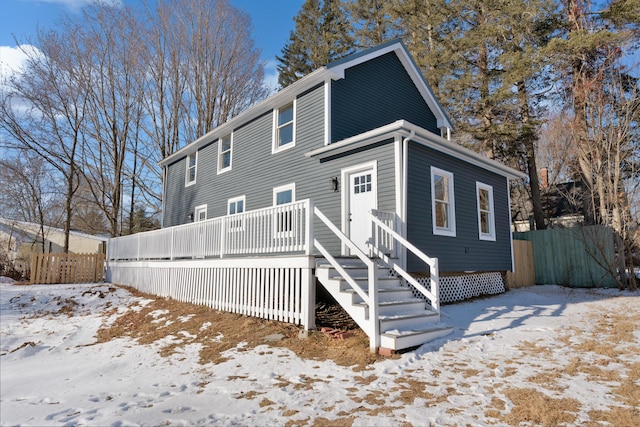 view of snow covered rear of property