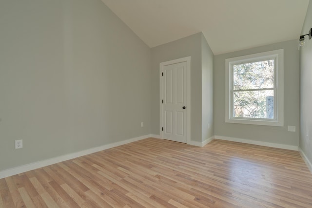 additional living space featuring lofted ceiling and light wood-type flooring