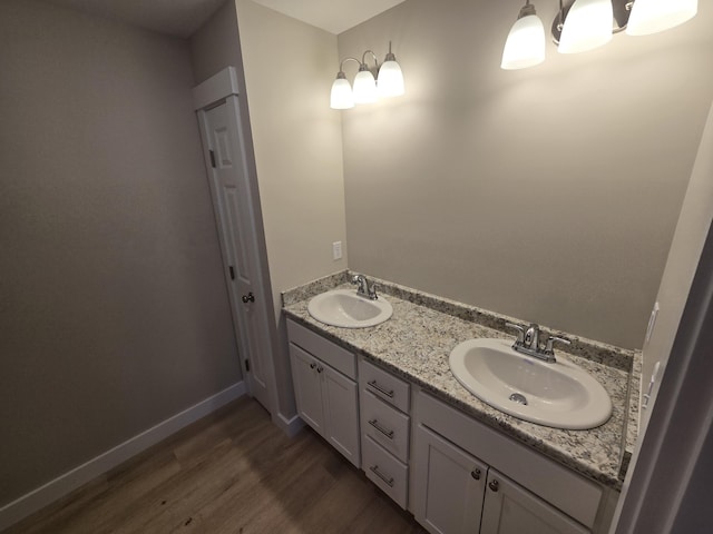 bathroom with hardwood / wood-style floors and vanity