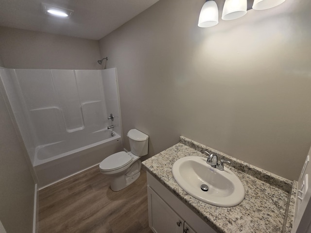 full bathroom with toilet, shower / bathtub combination, wood-type flooring, and vanity