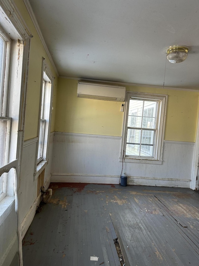 unfurnished room featuring an AC wall unit and dark wood-type flooring