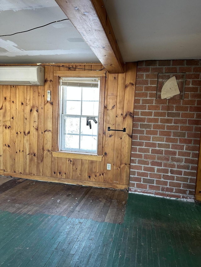 interior space with dark hardwood / wood-style flooring, wooden walls, beamed ceiling, and a wall mounted AC