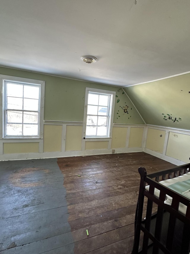 additional living space featuring vaulted ceiling and hardwood / wood-style floors