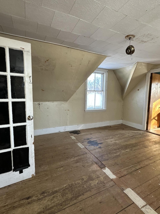 bonus room featuring wood-type flooring and vaulted ceiling