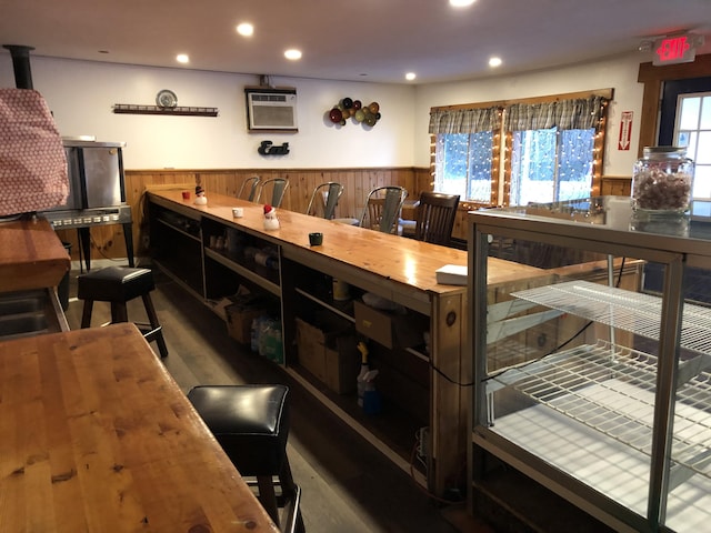 bar featuring wood walls, a wealth of natural light, and a wall mounted AC