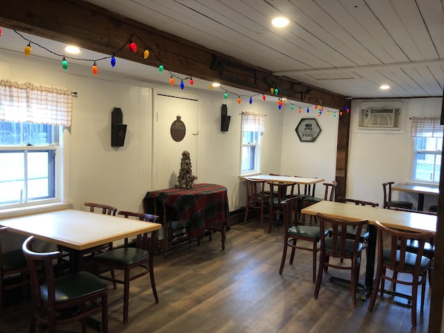 dining area featuring dark hardwood / wood-style flooring, wooden ceiling, and a wall mounted air conditioner