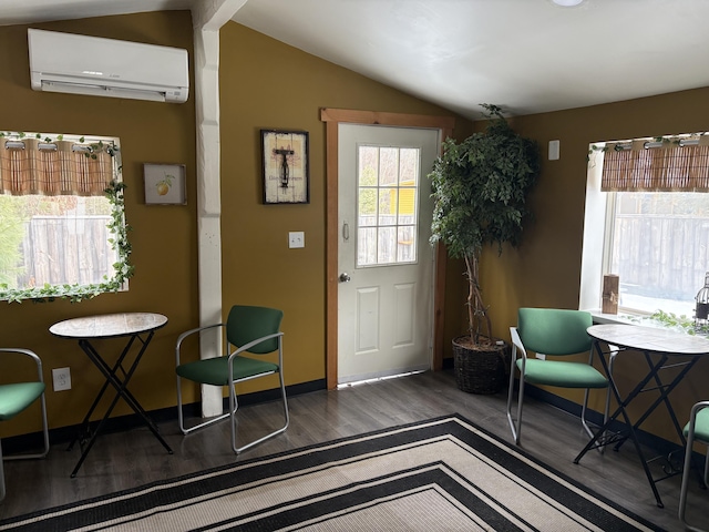 doorway featuring lofted ceiling, a wall mounted air conditioner, and dark hardwood / wood-style floors