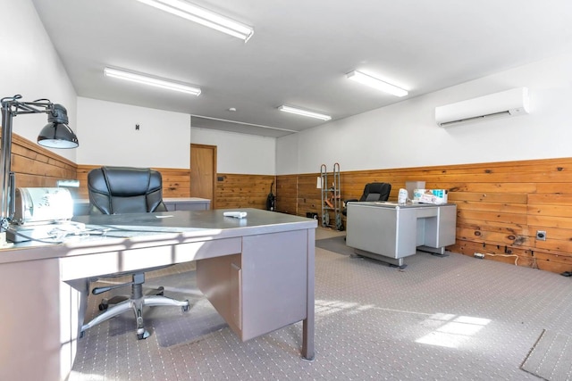 carpeted home office featuring a wall mounted AC and wood walls