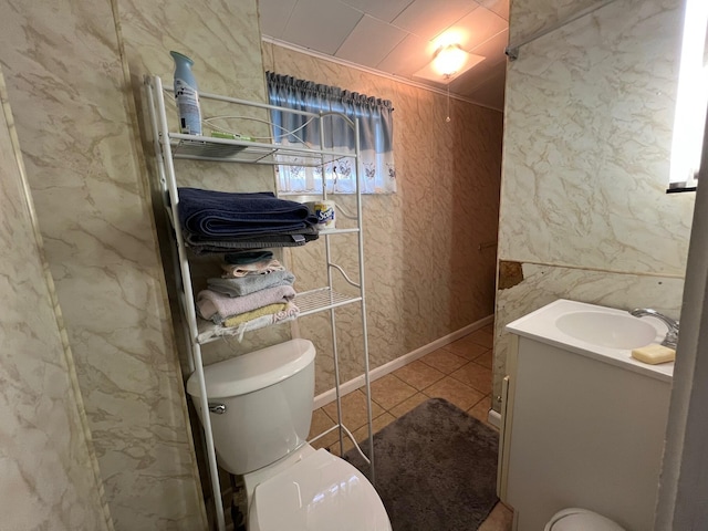 bathroom with vanity, tile patterned floors, and toilet