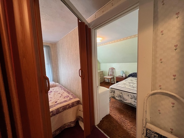 bedroom with lofted ceiling and a textured ceiling