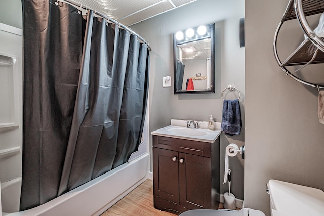 full bathroom with vanity, wood-type flooring, shower / bath combo, and toilet