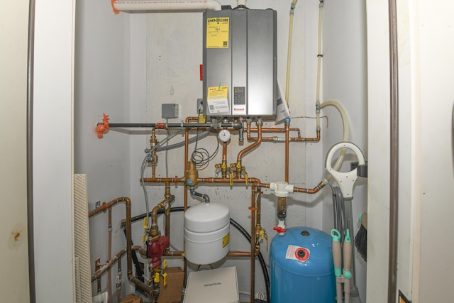 utility room featuring tankless water heater