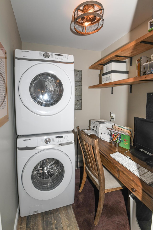 washroom featuring stacked washing maching and dryer and dark hardwood / wood-style flooring