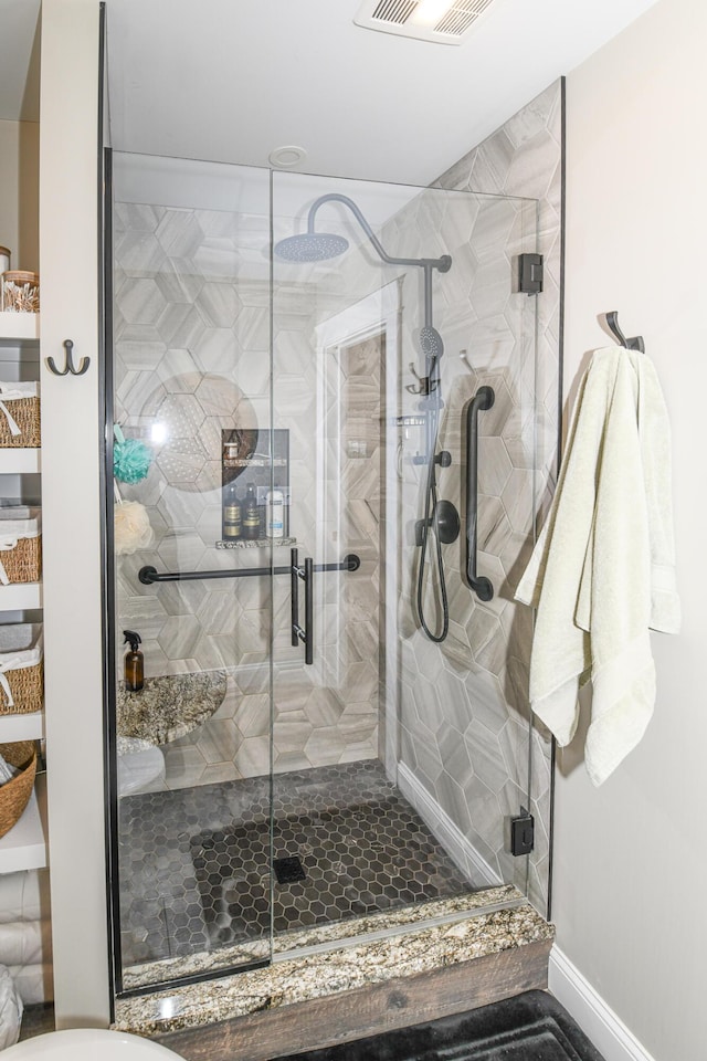 bathroom featuring a shower with shower door