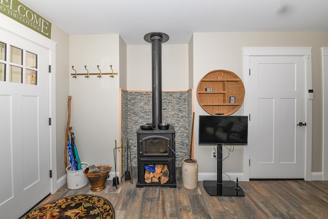 living room featuring a wood stove and dark hardwood / wood-style flooring