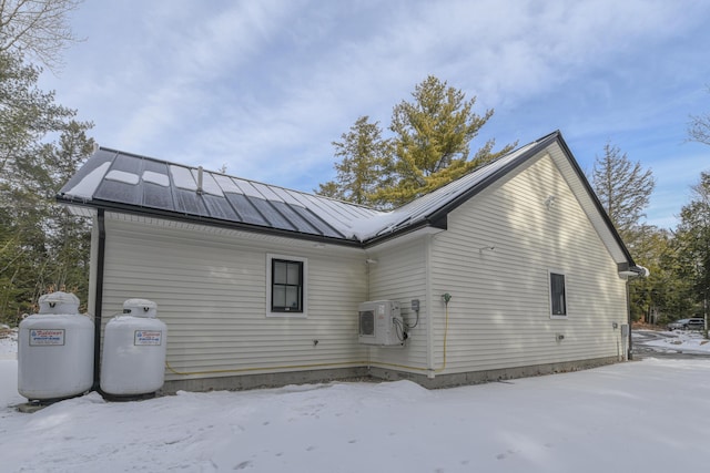 snow covered house with ac unit