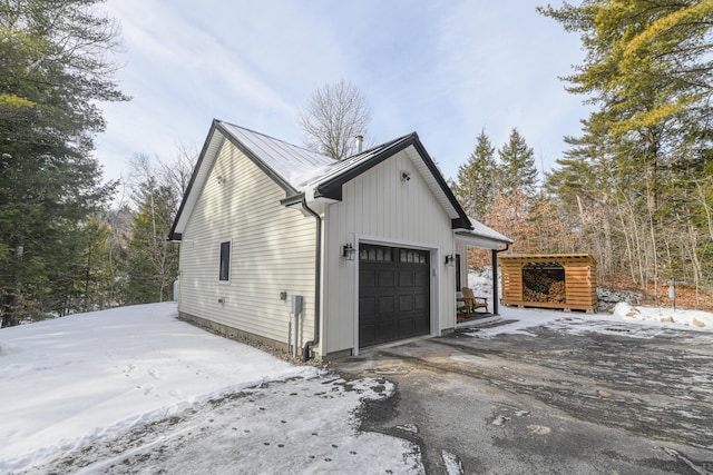 snow covered property featuring a garage