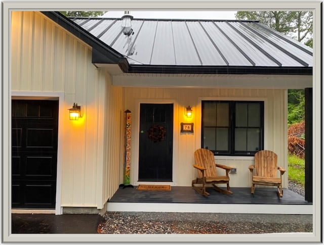 view of exterior entry with covered porch