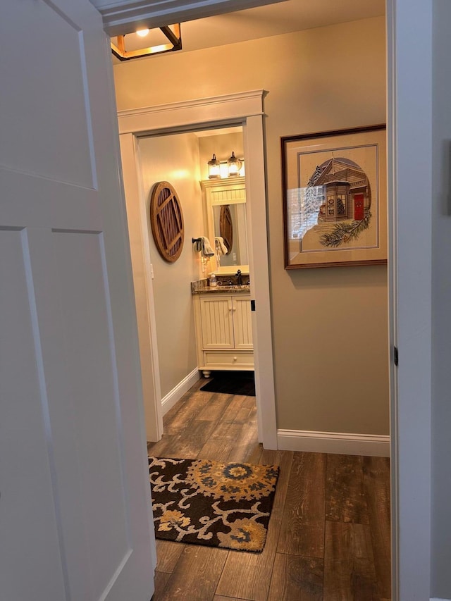 hall with dark wood-type flooring and sink