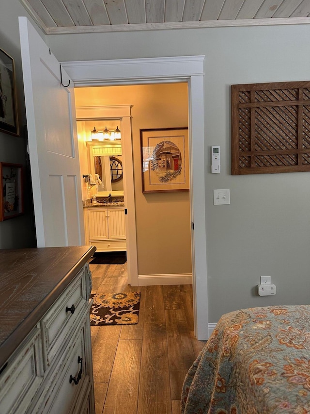 bedroom with sink, hardwood / wood-style floors, and wood ceiling