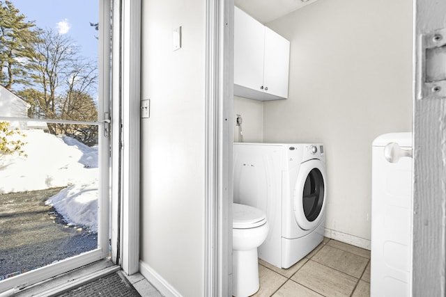 laundry area featuring washer / dryer and light tile patterned floors