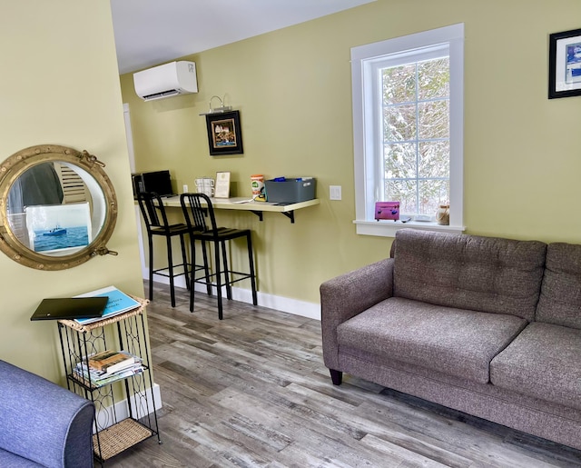 living room with hardwood / wood-style floors and a wall mounted air conditioner