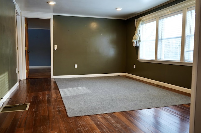 unfurnished room featuring dark hardwood / wood-style flooring and crown molding