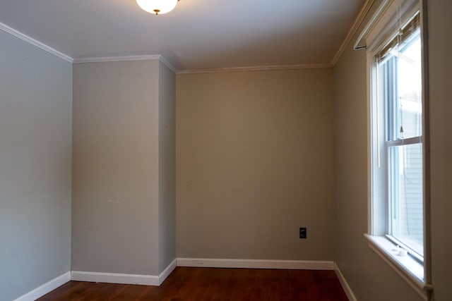 spare room with dark wood-type flooring, plenty of natural light, and crown molding