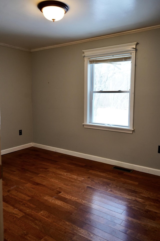 unfurnished room featuring dark hardwood / wood-style flooring and crown molding