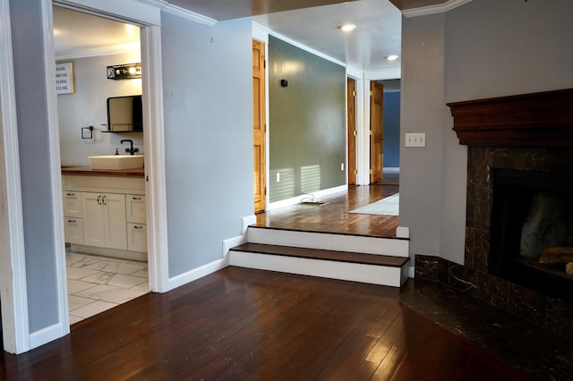 hall featuring sink and crown molding