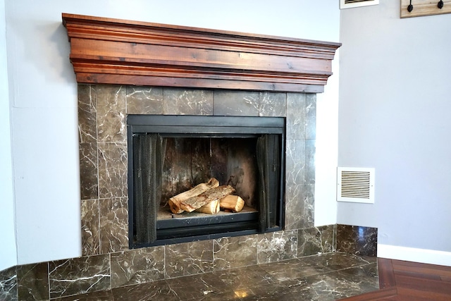 details featuring a tile fireplace