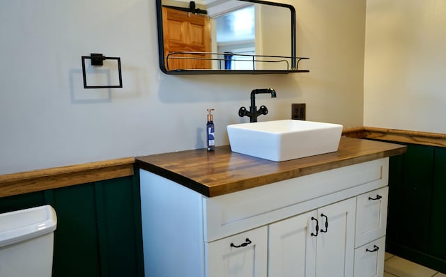 bathroom featuring toilet and vanity