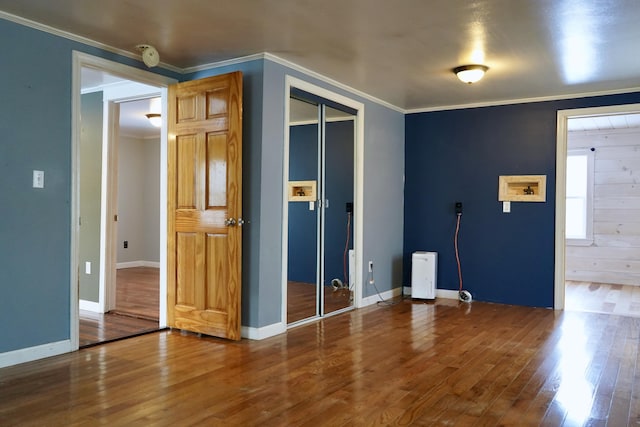 entrance foyer featuring ornamental molding and hardwood / wood-style flooring