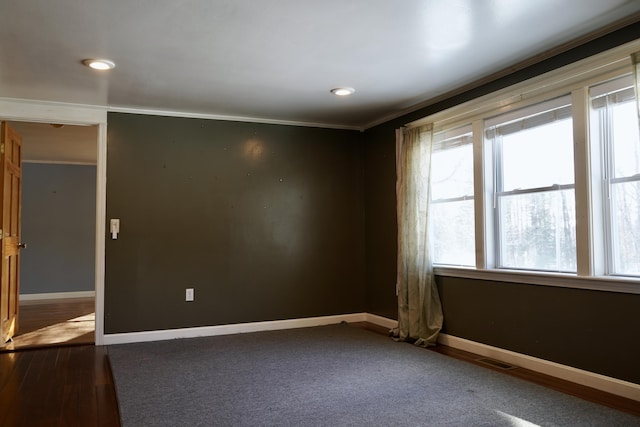 unfurnished room with a healthy amount of sunlight and crown molding