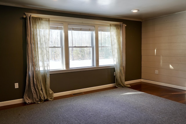 carpeted spare room featuring a wealth of natural light and crown molding