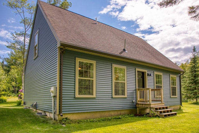 rear view of property featuring a yard