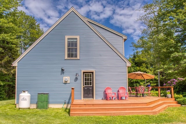 back of house with a deck and a yard