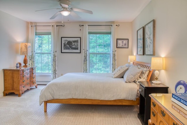 bedroom featuring ceiling fan, baseboard heating, and carpet floors