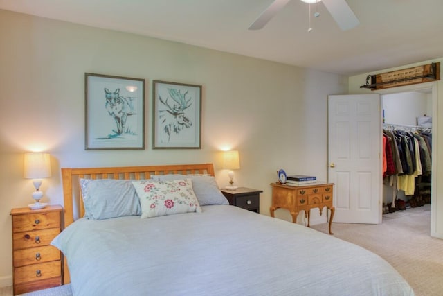 carpeted bedroom with a spacious closet, a closet, and ceiling fan