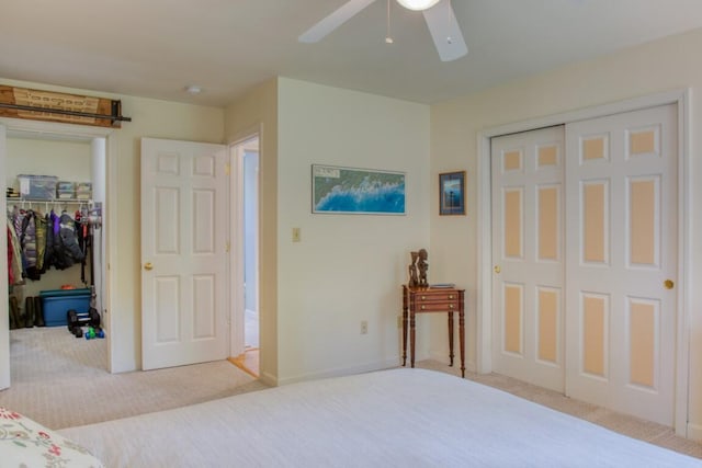 bedroom with ceiling fan and light carpet