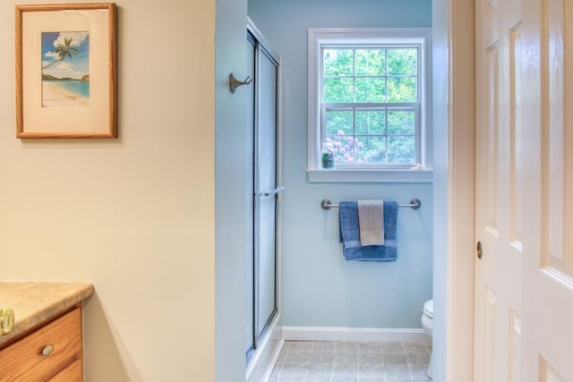 bathroom with toilet, walk in shower, and vanity