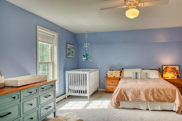 bedroom featuring ceiling fan, light carpet, and a baseboard radiator