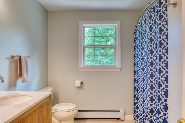 bathroom featuring toilet, vanity, and baseboard heating