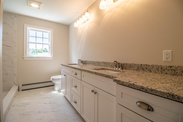 bathroom featuring a baseboard heating unit, vanity, and toilet